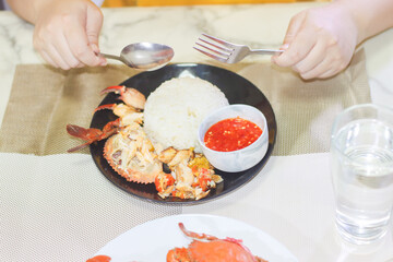 Person About to Eat Picked Mud Crab with Rice