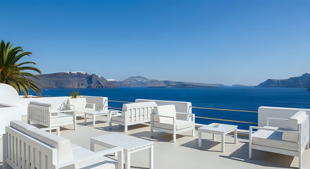 Fototapeta premium White furniture on a terrace overlooking the sea with a clear blue sky and distant islands view scene