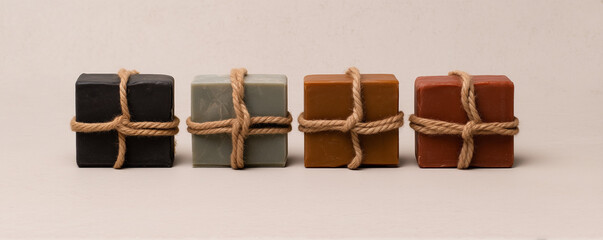 handcrafted soap bars tied with rope in various colors.