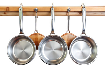 Shiny silver skillets hung on wooden rails isolated on a transparent background frying pan