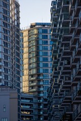 Glass balconies in multi-family buildings, apartment density, real estate, and housing market.