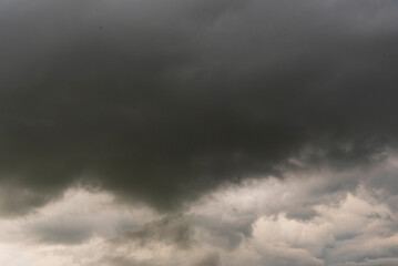 Obraz premium Dramatic dark storm thundercloud rain clouds on black sky background. Dark thunderstorm clouds rainny landscape. Meteorology danger windstorm disaster climate. Dark cloudscape storm disaster gray sky