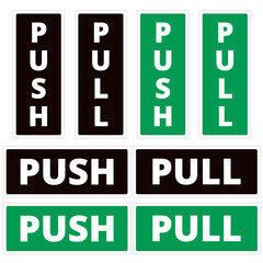 Black and green push and pull door signs isolated on a white background