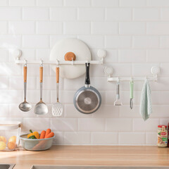 Bright kitchen interior with cookware, utensils, and organized countertop