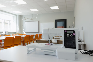Modern sewing machine in a bright classroom ready for creative projects and learning