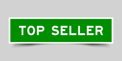 Green color square shape sticker label with word top seller on gray background