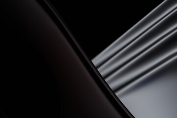 Abstract, dark, and light gray smooth shapes intersect, creating a dramatic contrast