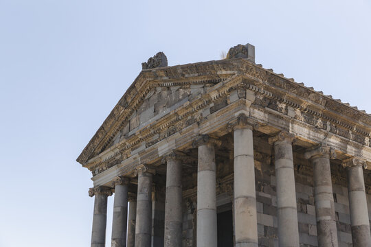 View of the Hellenistic Garni temple, a symphony of carved stone under a bright sky, standing as a testament to time and culture, Garni, Kotayk Province, Armenia.