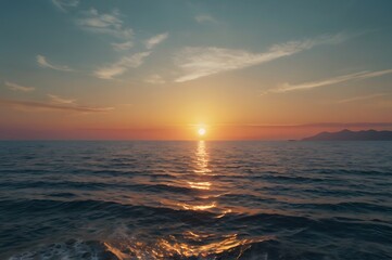 Obraz premium Sunset Over Ocean with Calm Water and Distant Mountains