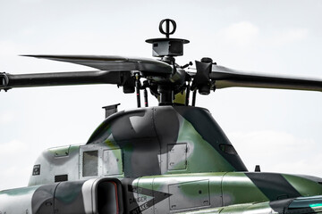 A close-up view of the main rotor of a military helicopter