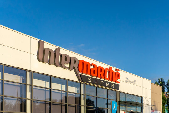 Front facade of Intermarch&eacute; Super market with large logo on building, visible entrance area and glass windows.