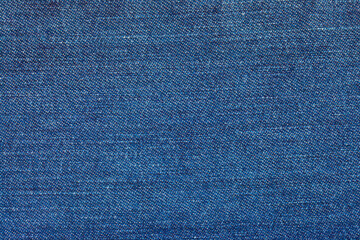Naklejka premium Abstract texture background of classic blue jeans denim fabric. A macro detail showing the distinctive diagonal twill weave and fibers of the material, ideal for fashion and design concepts