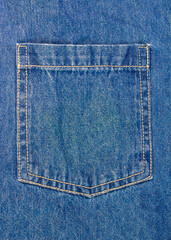A close-up of a pocket on blue jeans. The classic denim pocket with its light-colored double stitching is an iconic and timeless element of casual fashion design