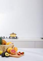 Still life of fresh fruits on wooden table in kitchen with soft lighting