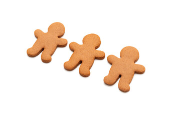 Three gingerbread cookies in shape of men isolated on white background