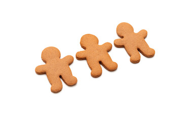 Three gingerbread cookies in shape of men isolated on white background