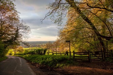 Cotswolds countryside with stile, Gloucestershire, England.
