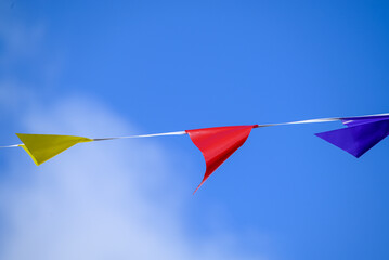 Colorful Party Flags Against a Blue Sky The Concept of a Celebration
