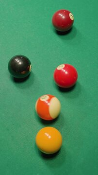 Vibrant billiard balls scattered across green pool table after powerful break shot, rolling in various directions. Dynamic motion and sharp contrast capture intensity of game