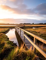 Wooden walkway over a tranquil waterway at sunrise
