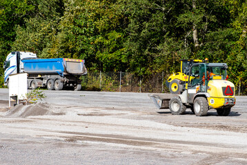 Road repair, vehicles and bulldozer paving.