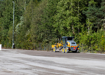 Road repair, vehicles and bulldozer paving.