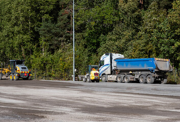 Road repair, vehicles and bulldozer paving.