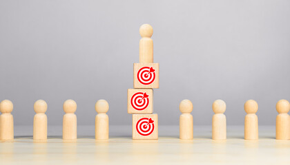 Successful Leader. wooden figures of people symbol and target icon on wooden cube