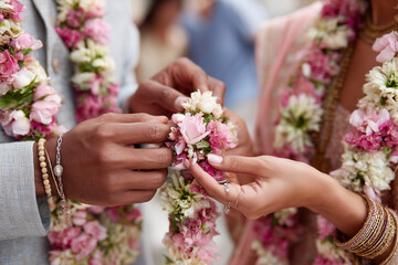 Bride and groom exchanging garlands during Hindu wedding ritual, 