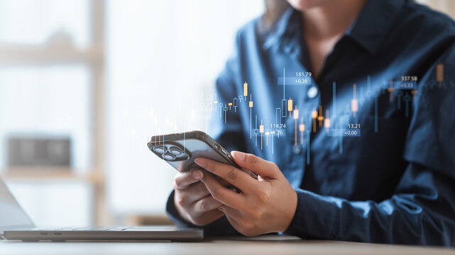 Person using smartphone with stock market chart overlay, symbolizing digital finance, stock trading, investment strategy, and financial market analysis in modern economy.