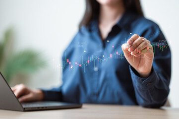 Businesswoman analyzing stock market chart with laptop, symbolizing finance, stock trading, investment strategy, financial market growth, and modern economic planning.