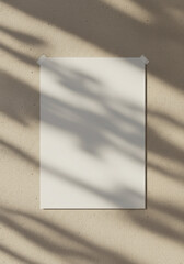Blank vertical white paper mockup with soft natural botanical shadows cast across its surface.
