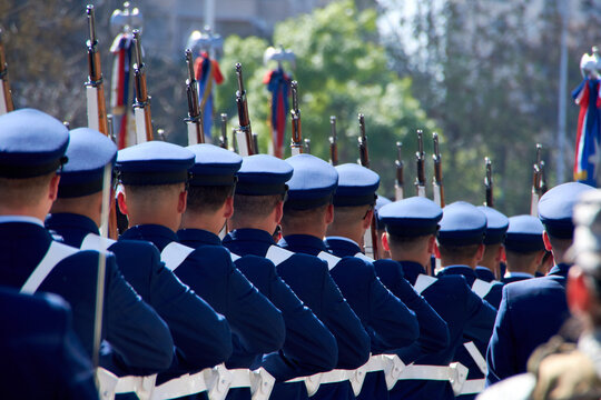 Chilean Air Force soldiers marching in a military parade in the street.
