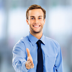 Businessman business man wear corporate blue shirt, dark tie giving hand for handshake, stand against blurred office background. Wellcome partner concept. Square image