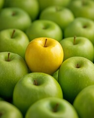 Golden Apple Among Greens: A close-up shot showcases a striking yellow apple positioned among a crowd of crisp, green apples.
