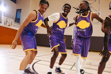 Basketball teammates celebrating victory with dance