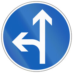 Regulatory road sign in Finland - Go straight ahead or turn left