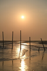 The exit of the sea and the pole under the morning sun