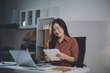 Portrait of young Hispanic professional business woman standing in office. Happy female company executive, smiling businesswoman entrepreneur corporate leader manager looking at camera using tablet