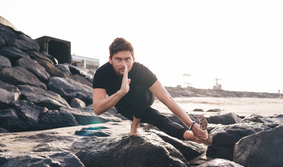 Focused yogi in deep asana, one hand on instep: embodying digital concentration, code-like precision, sensorimotor integration and mindful presence for tech-infused performance.