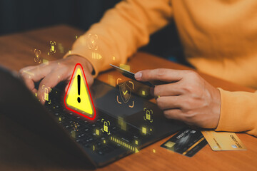 Cybersecurity warning concept with customer using laptop computer and credit card, symbolizing online fraud, identity theft, payment scam, financial risk, data breach, and internet security alert.