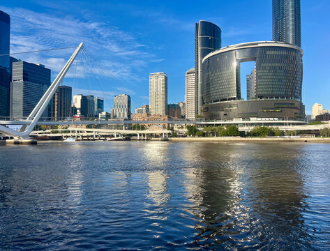 View into land from the South Bank of the city skyline, Neville Bonner Bridge and reflections in the Brisbane River, Brisbane, Queensland, Australia
