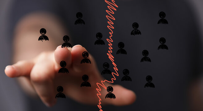 Hand interacting with declining graph, symbolizing job losses, economic downturn, workforce reduction.