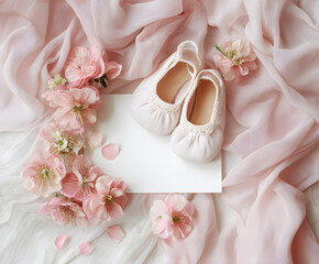 Baby girl shower flat lay with pink shoes on blank card, surrounded by soft fabric and flowers. Ideal for newborn announcement, invitation, or christening design.
