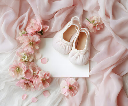 Baby girl shower flat lay with pink shoes on blank card, surrounded by soft fabric and flowers. Ideal for newborn announcement, invitation, or christening design.
