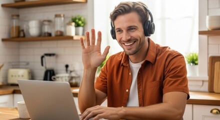 Young man on video call working remotely from home kitchen