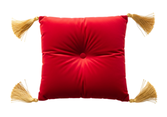 A rich, red velvet cushion, adorned with elegant gold tassels, sits centered against a black backdrop.