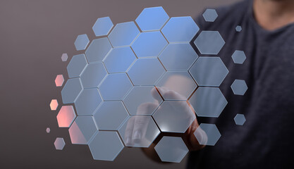 Hand interacting with a digital hexagon network.  Modern technology, connection, innovation.