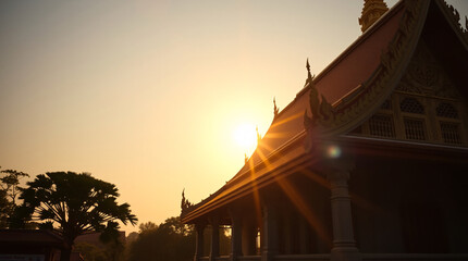 Glorious Sunbeams and Lens Flare Illuminating a Thai Temple with a Traditional Gabled Roof