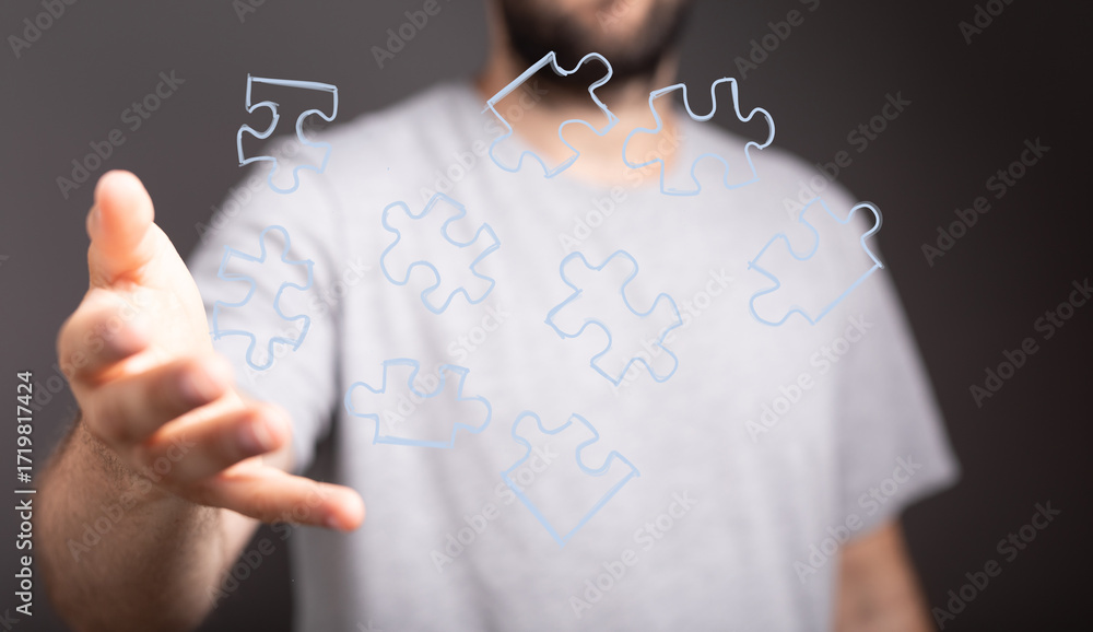 Poster abstract image of a man reaching for puzzle pieces, symbolizing problem-solving and connection.